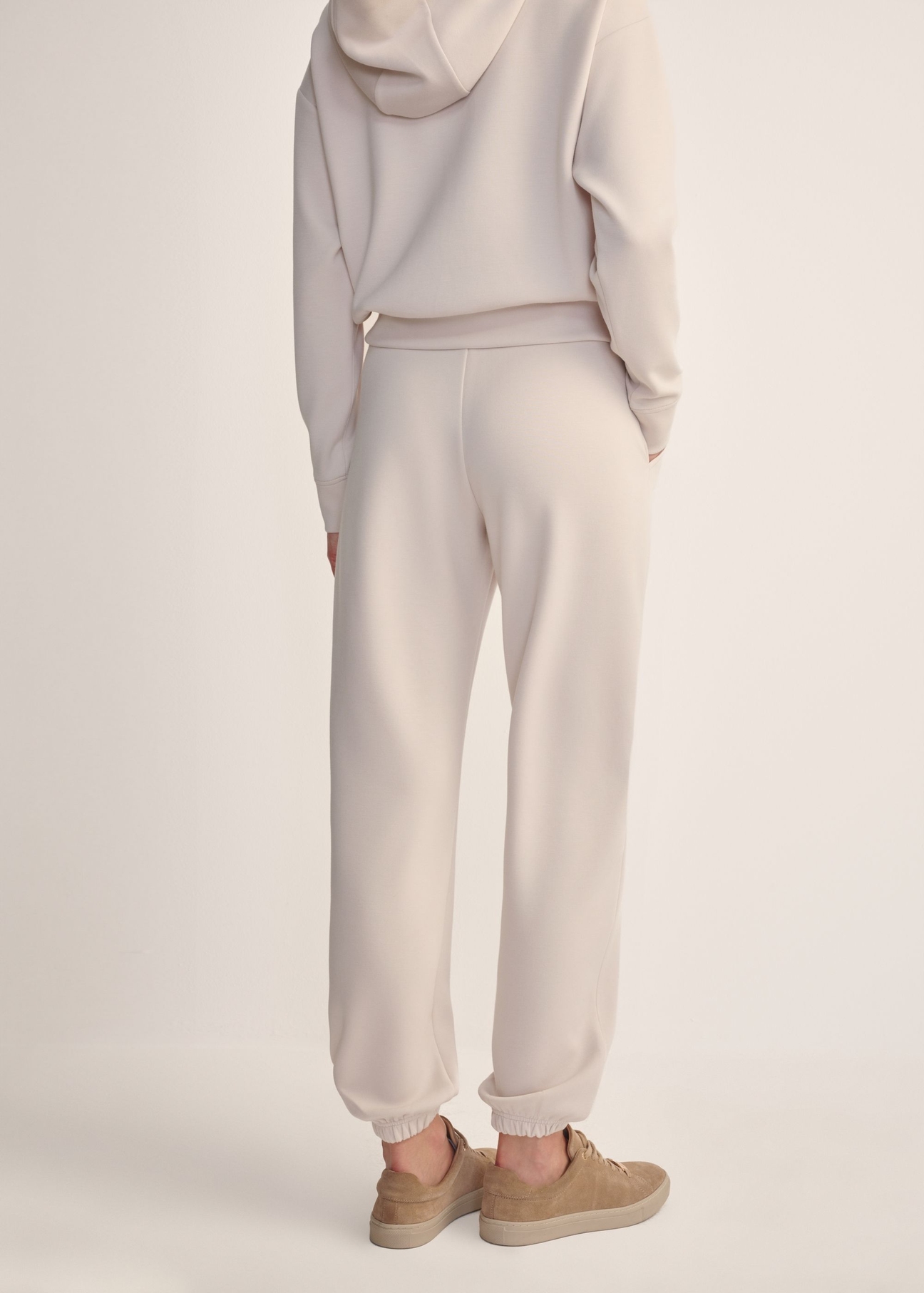 Light beige women's trousers SPODT-0117-80(Z25), back view of the product on the model. Half of the silhouette visible.