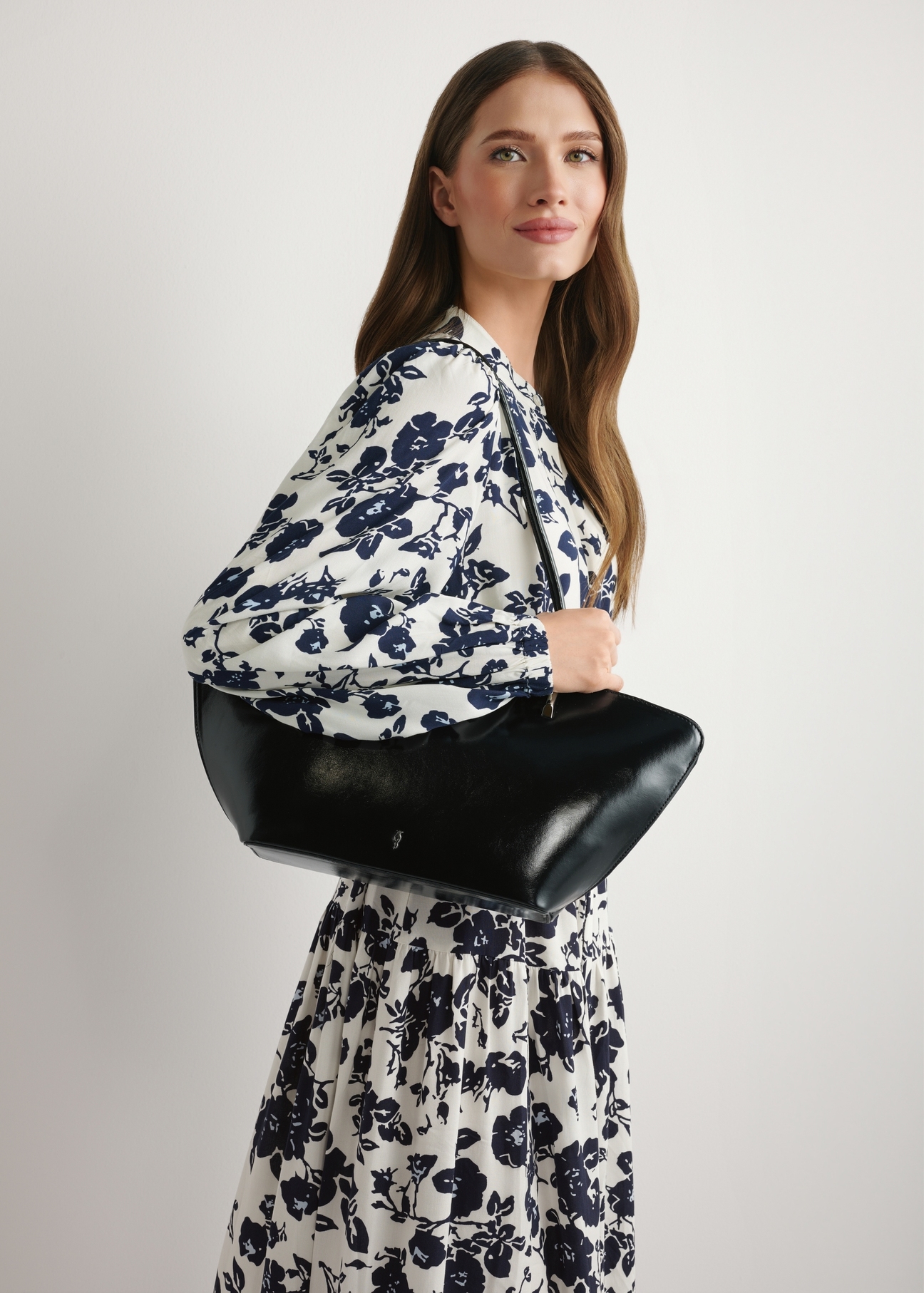 Black women's shoulder bag TOREC-1237-99(W26) - front view of the product, on a model, against a light background. Half of the silhouette visible.