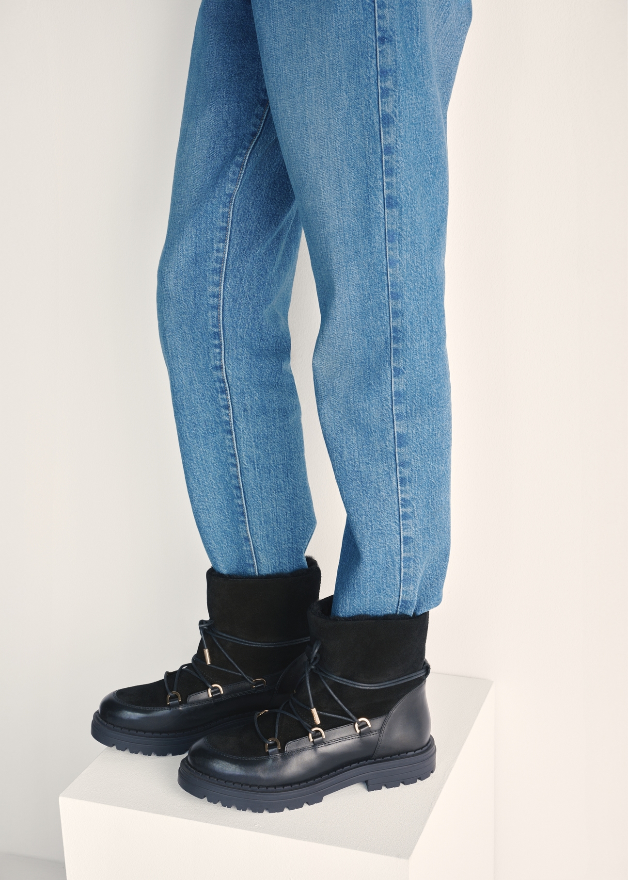 Women's black suede snow boots BUTYD-1201-99(Z25) - side view of the product on a model against a white background. Half of the silhouette visible.