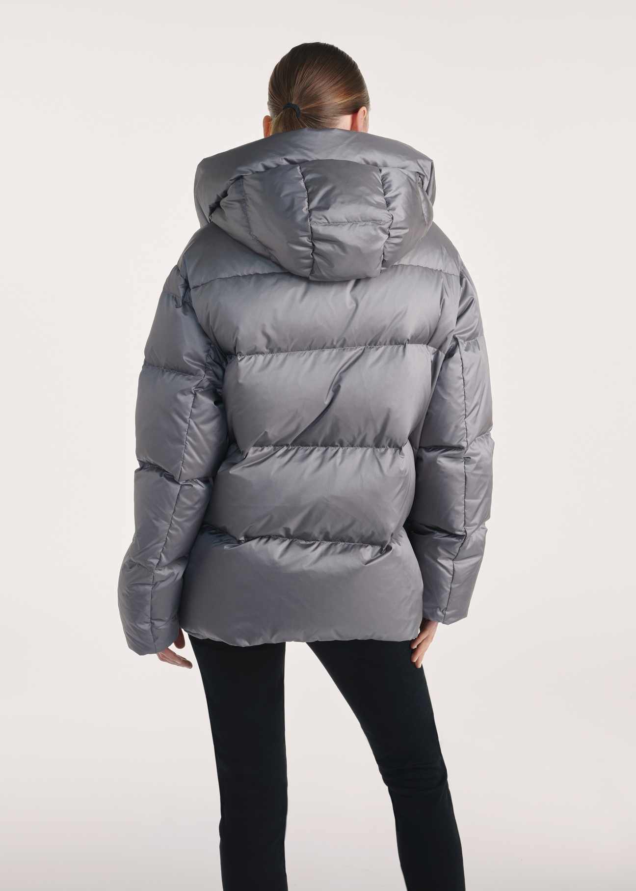 Gray women's down jacket KURDT-0585-91(Z25), product view from the back on the model, half of the silhouette visible.
