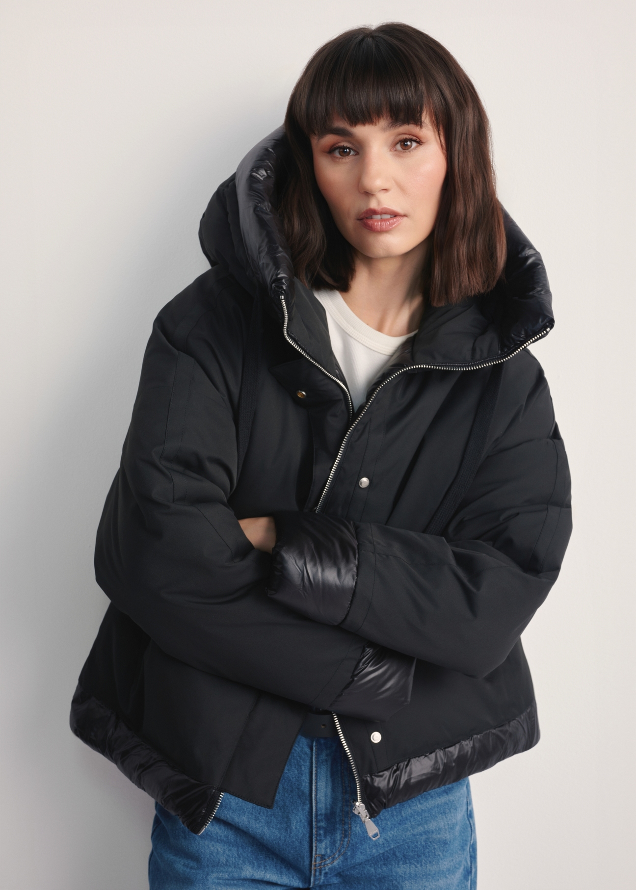 Black oversized women's jacket KURDT-0605-99(Z25), front view of the product on the model. Half of the silhouette visible.