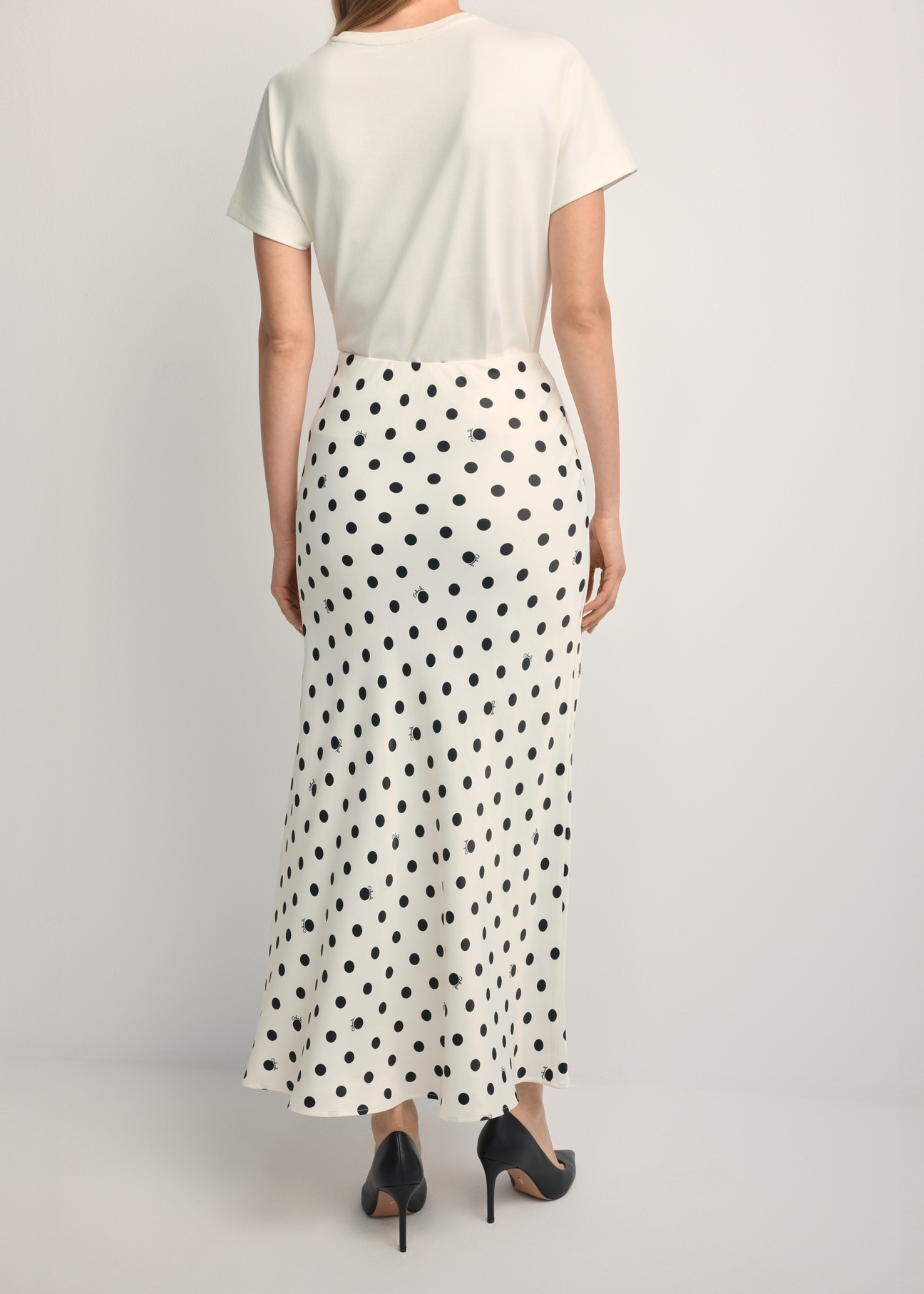 Women's white polka dot skirt SPCDT-0122-0P(W26), back view of the product on the model. Half of the silhouette visible.