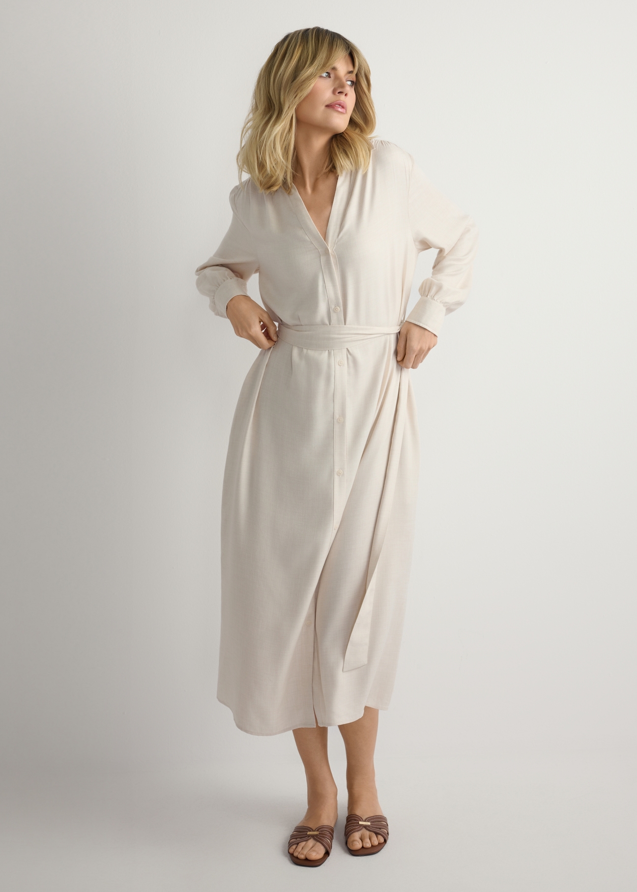 Light beige women's midi dress SUKDT-0269-1A(W26), front view of the product on the model. Half of the silhouette visible.