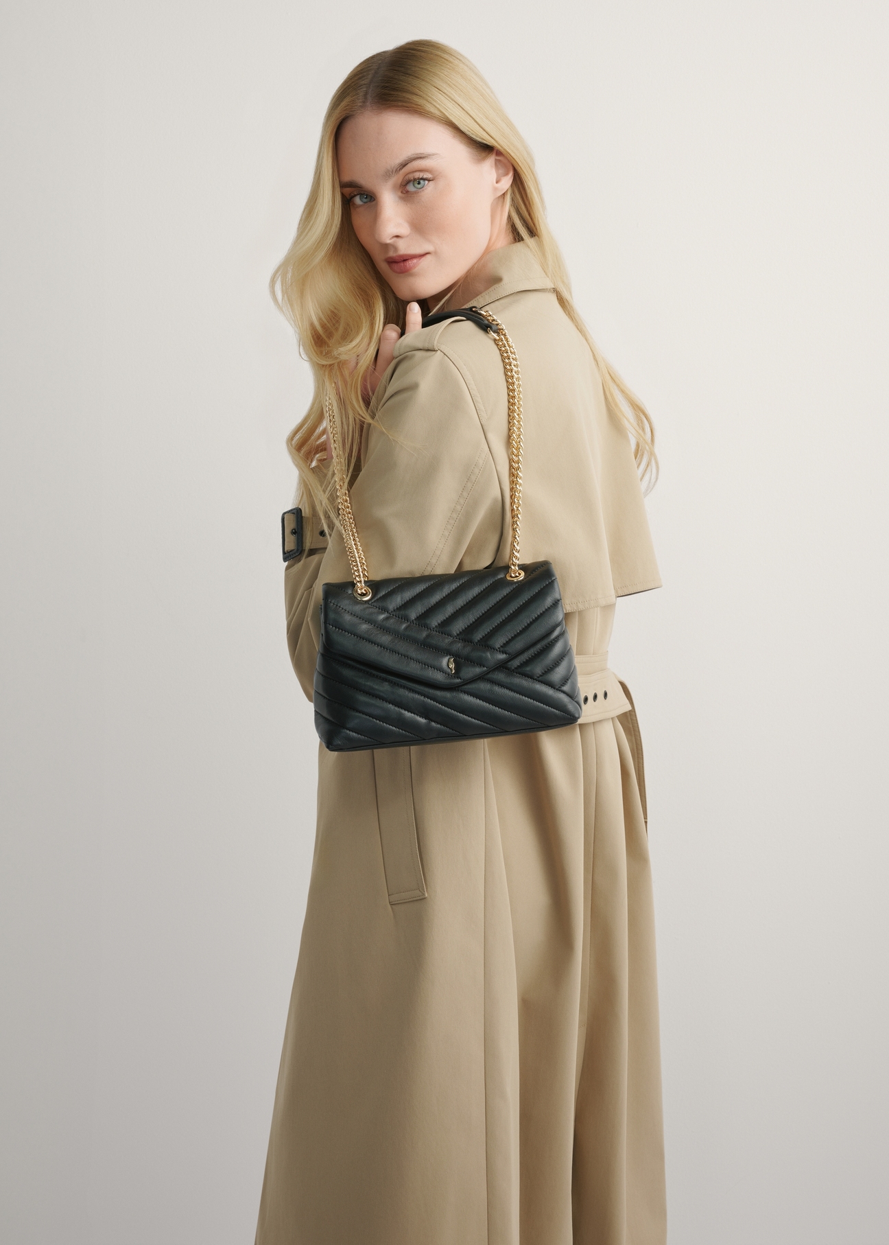 Women's black leather handbag TORES-1285-99(W26) - product view on a model, against a light background. Half of the silhouette visible.