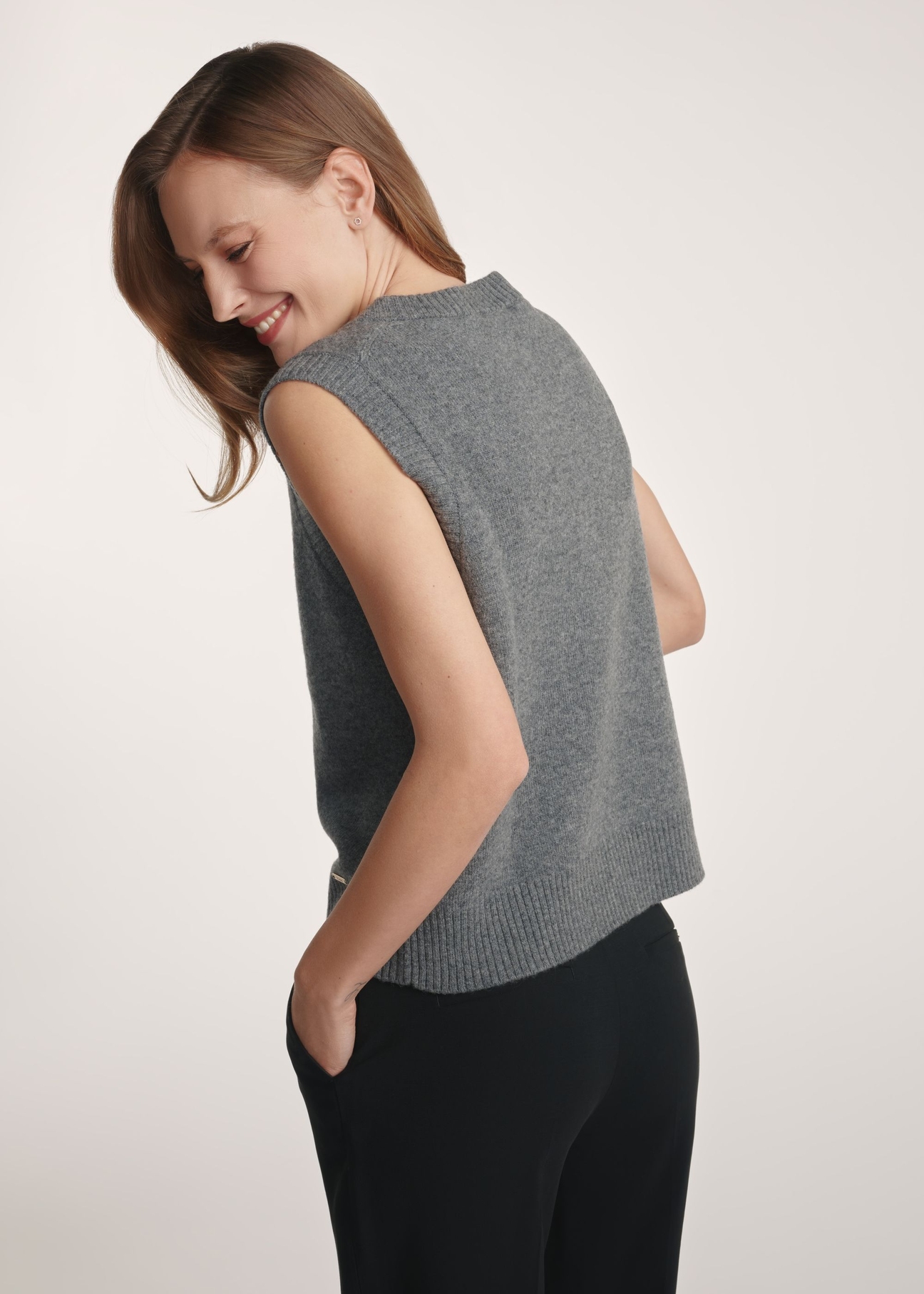 Women's woolen vest in gray color SWEDT-0253-9D(Z26) - product visible from the back on the model, half of the silhouette visible.