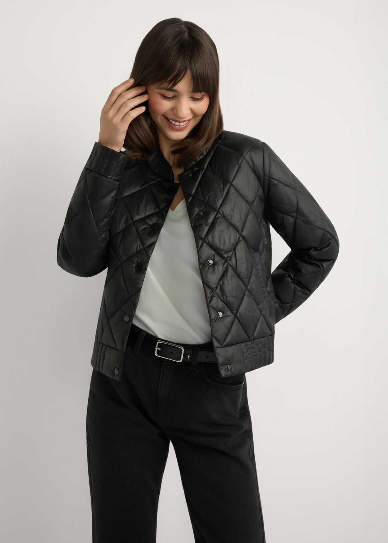 Women's black transitional jacket KURDT-0564A-99(W26), front view of the product on the model. Half of the silhouette visible.