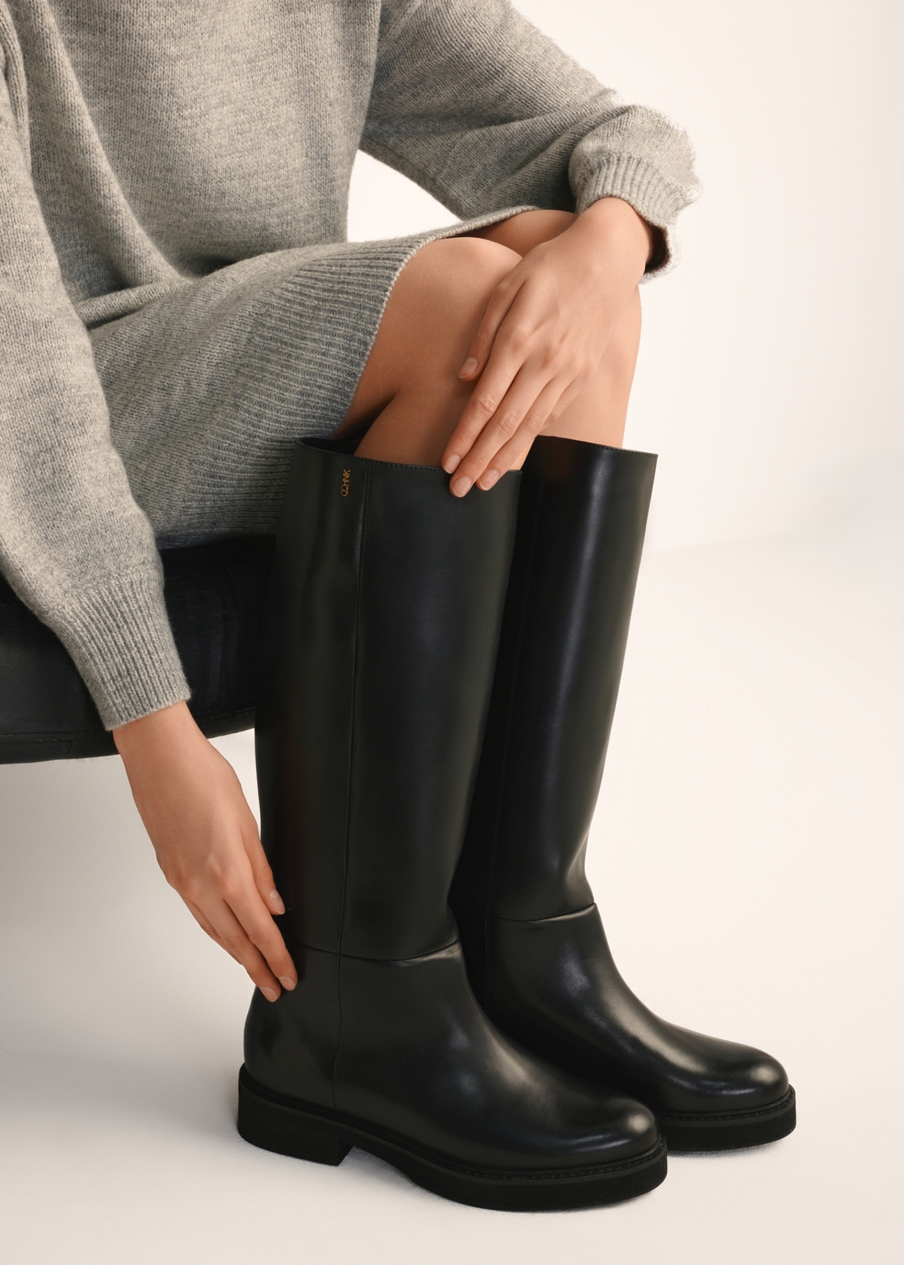 Women's leather boots in black BUTYD-1195-99(Z25), side view of the product on the model's feet.