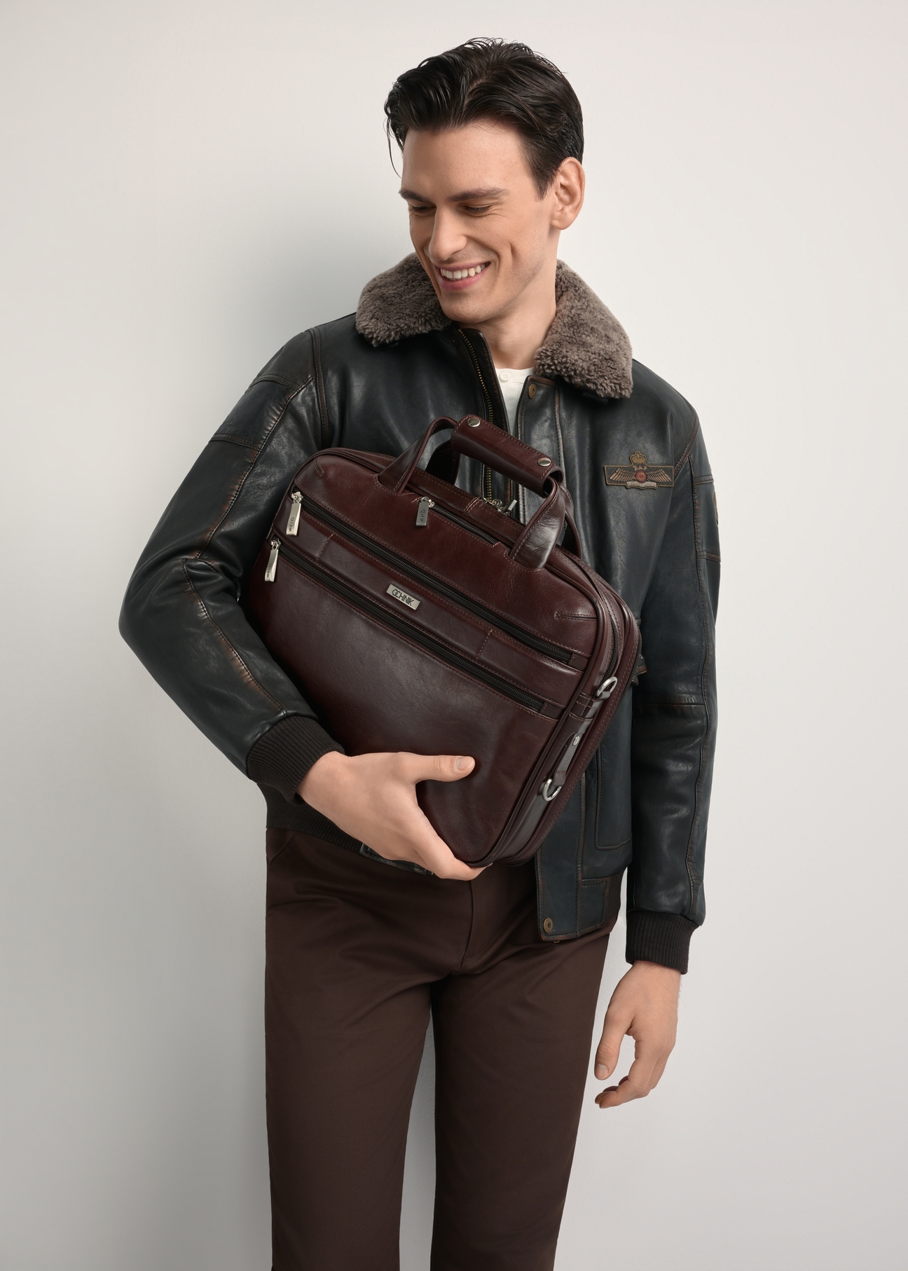 Brown leather men's bag TORMS-0483-89(Z25) - front product view, modeled on white background. Half silhouette visible.