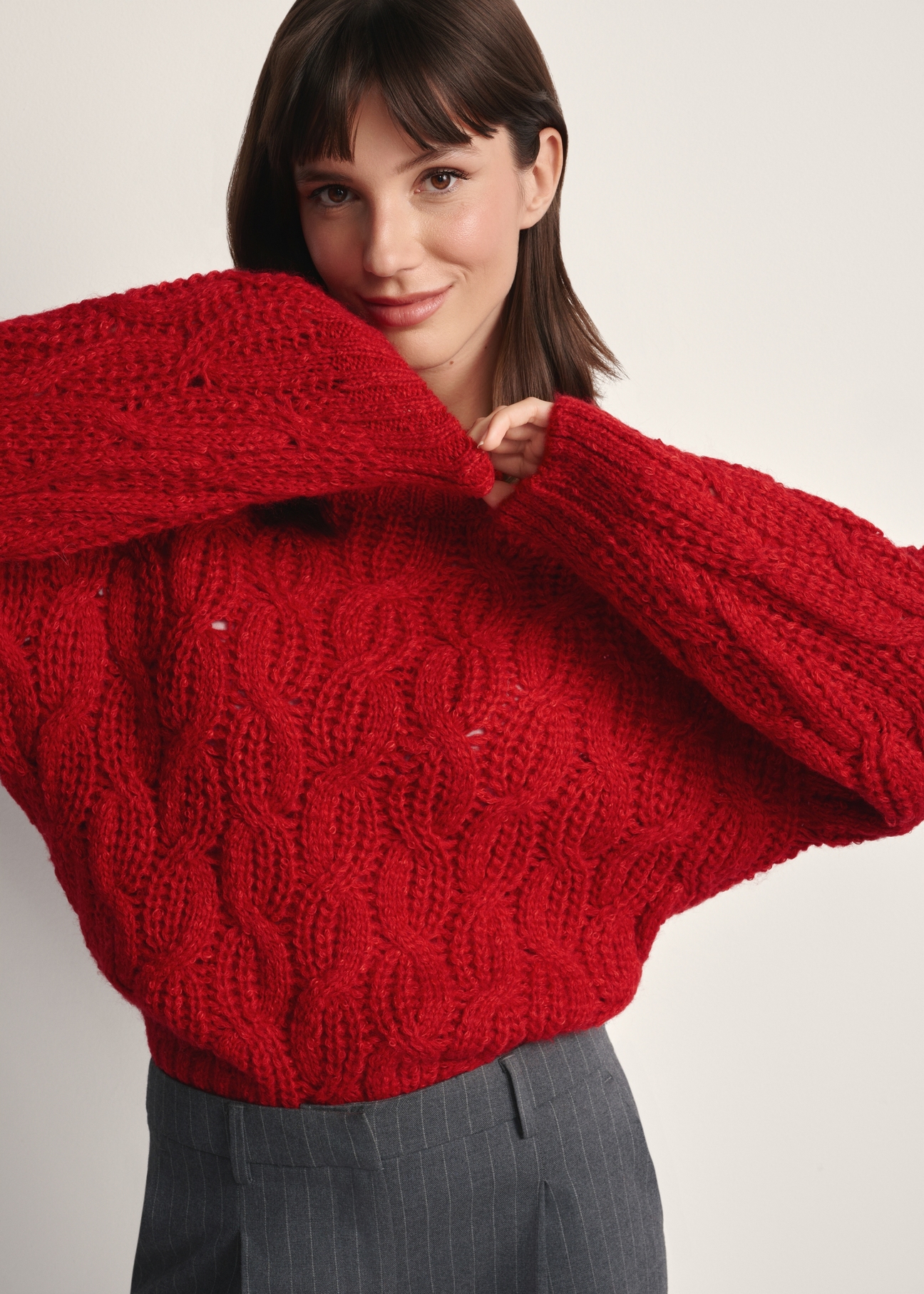 Red women's sweater SWEDT-0236-42(Z25), front view of the product on the model. Half of the silhouette visible.