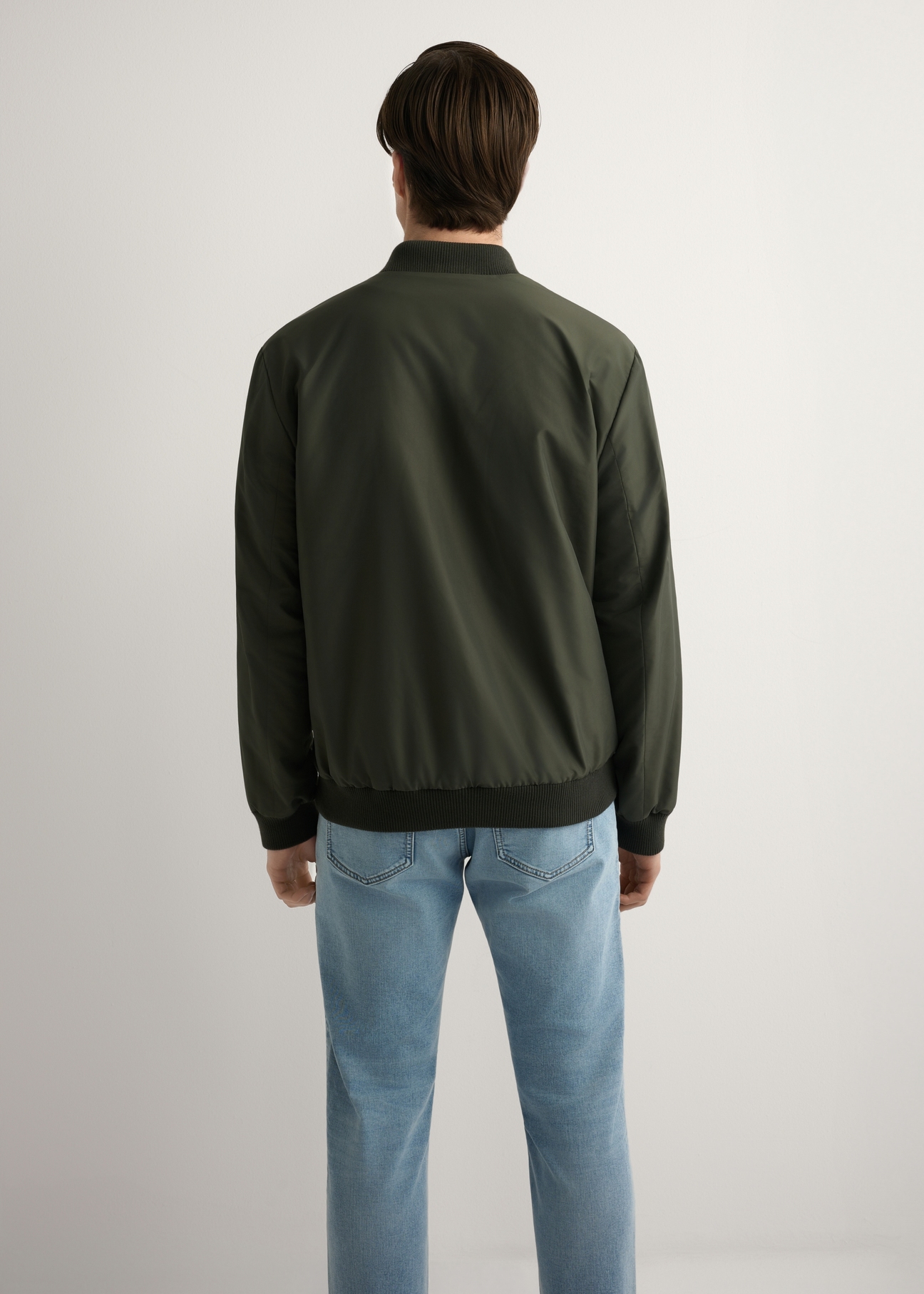Men's khaki bomber jacket KURMT-0413-8D(W26) - back view of the product, on a model, against a light background. Half of the silhouette visible.