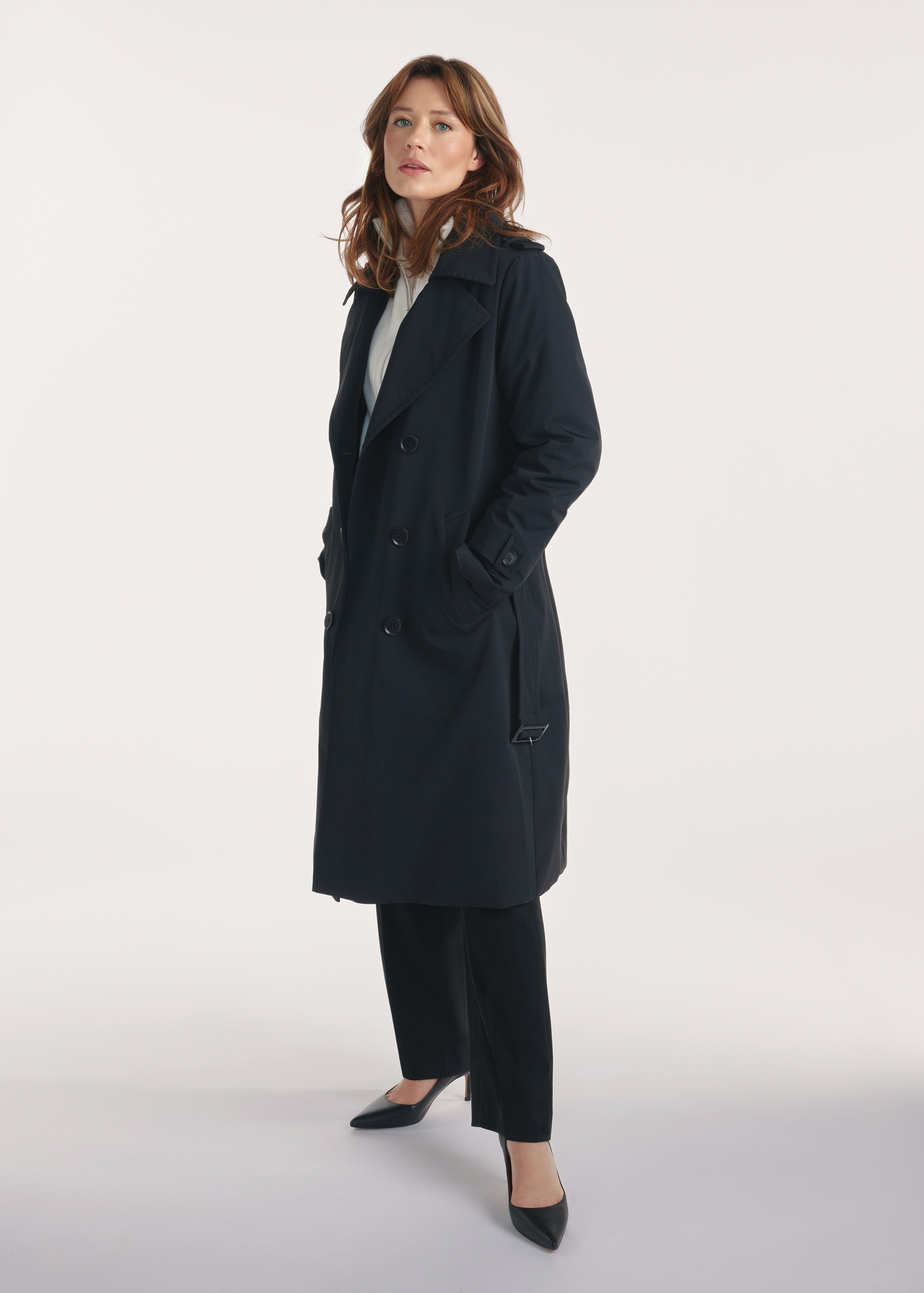 Black women's coat with insulation KURDT-0610-99(Z25), front view of the product on the model, the whole silhouette is visible.