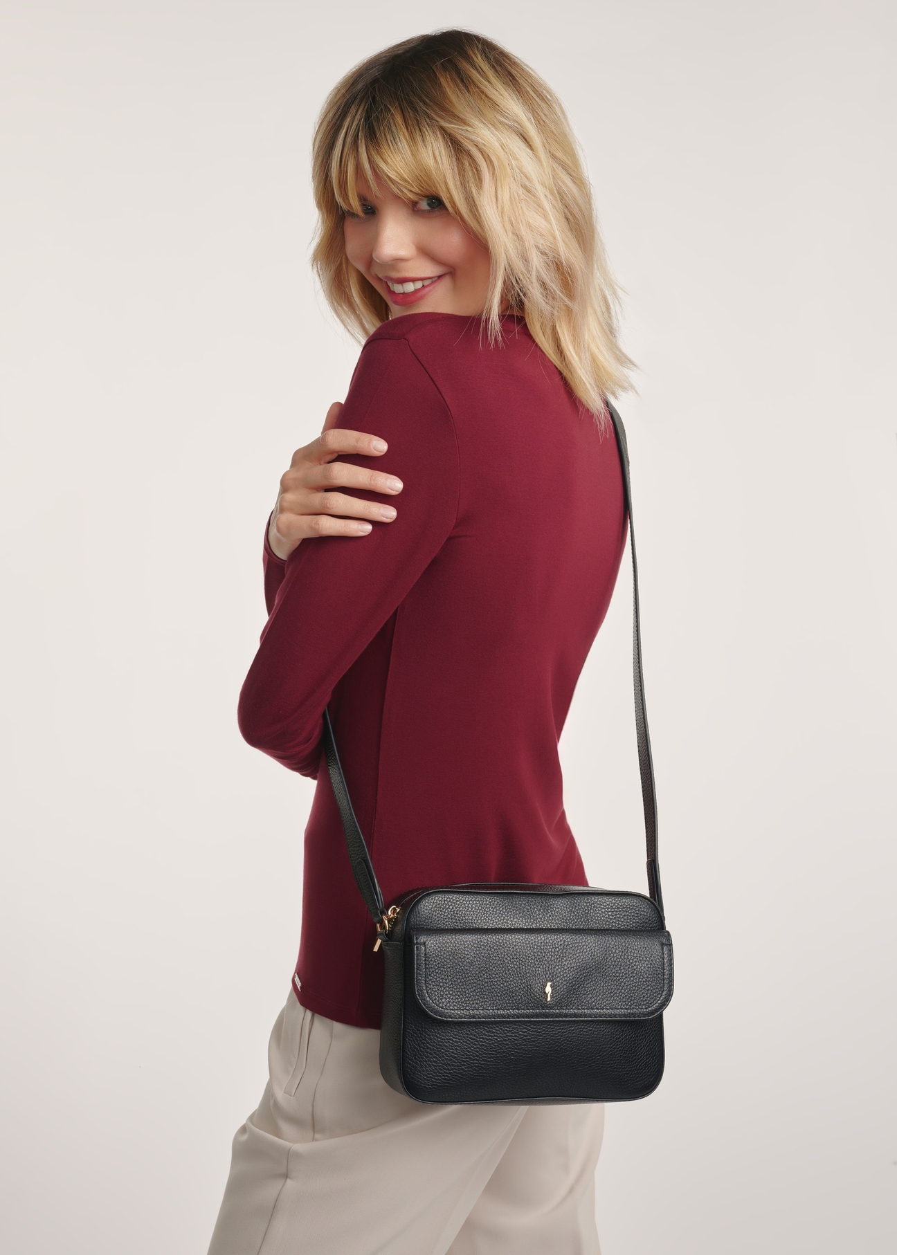 Women's leather black messenger bag TORES-1155-99(Z25) - product view on a model on a white background.