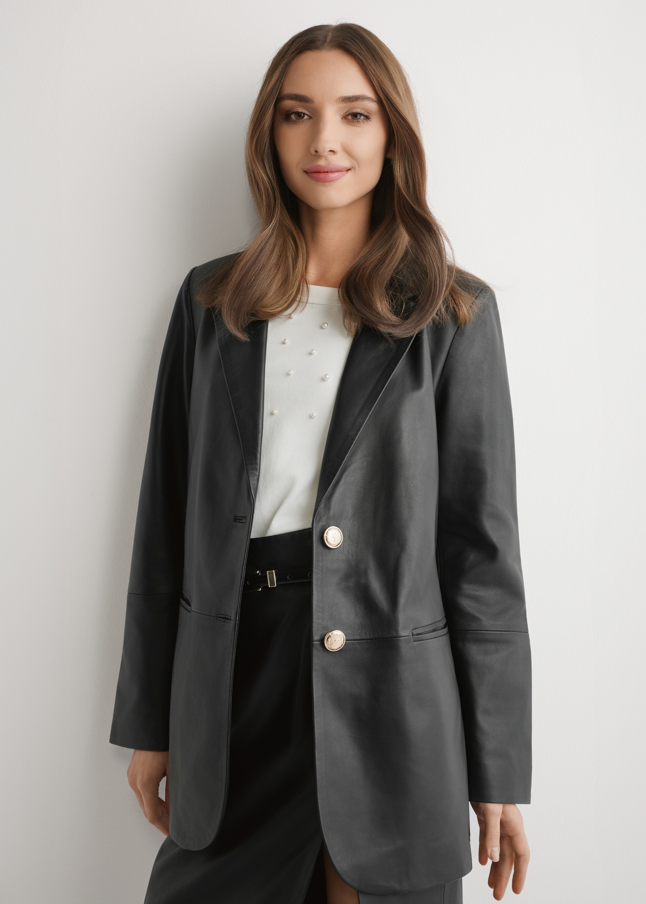 Women's black leather jacket KURDS-0606-99(W26) - front product view, modeled, against a light background. Knee-length silhouette visible.