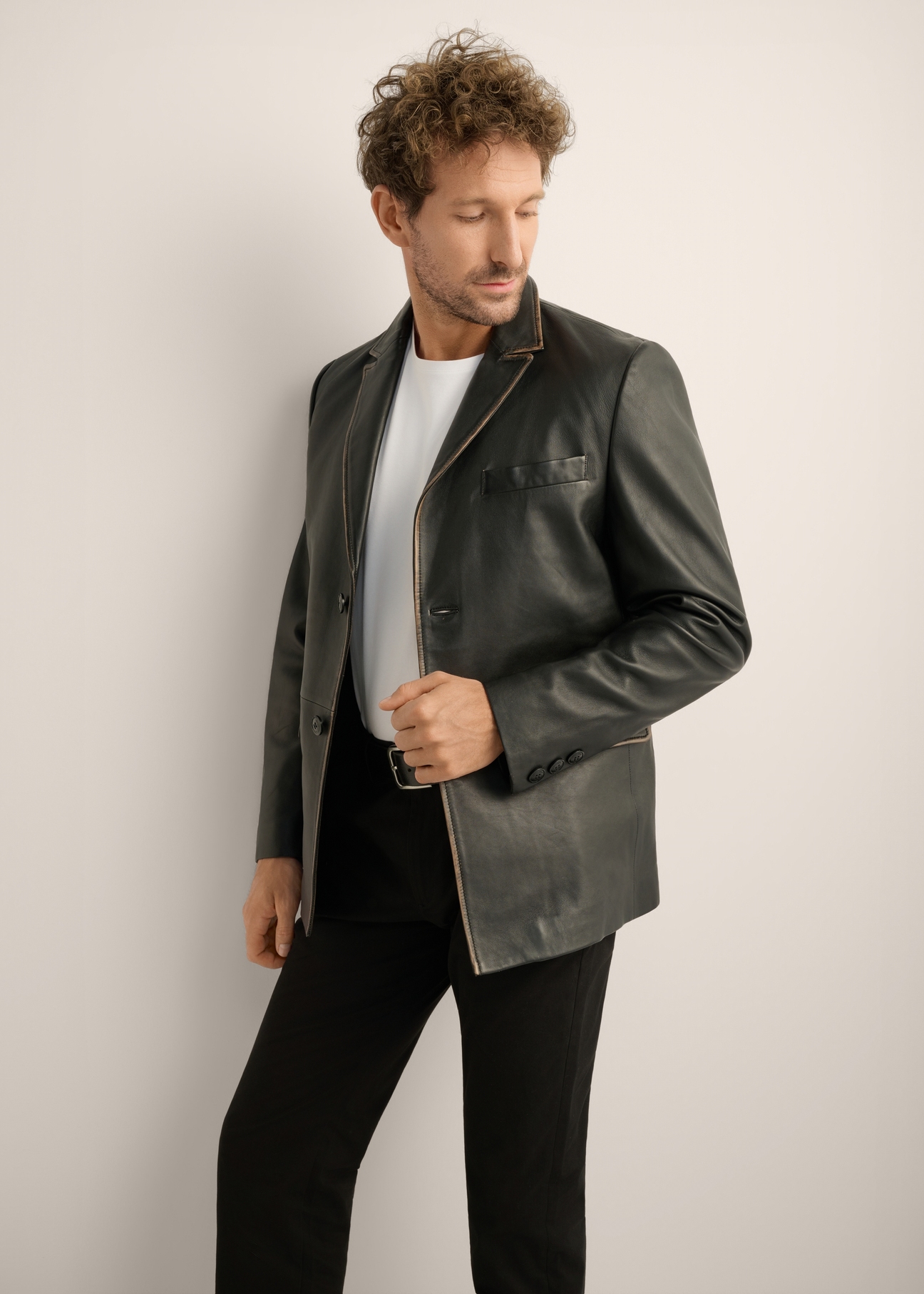 Black vintage men's leather jacket KURMS-0402-9J(Z26). Front view of the product on a model. Half of the silhouette is visible. 