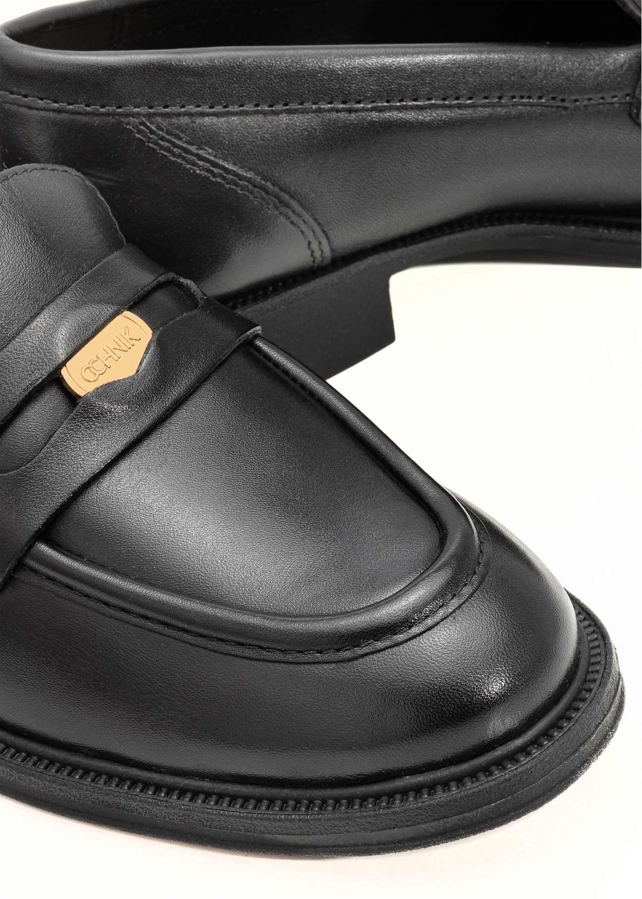 Women's black leather moccasins with logo BUTYD-1199-99(Z25), close-up of product detail on white background.