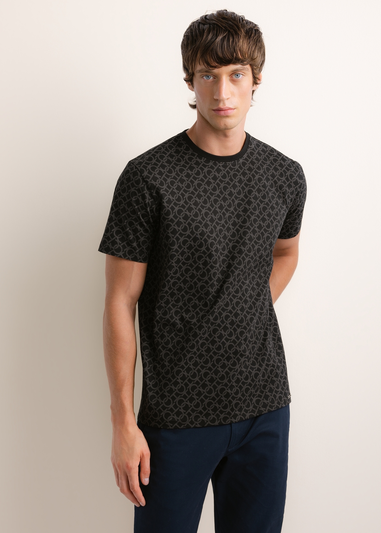 Men's cotton T-shirt with a monogram pattern (TSHMT-0163-99(Z26)); front view of the product on a model. Half of the figure is visible.
