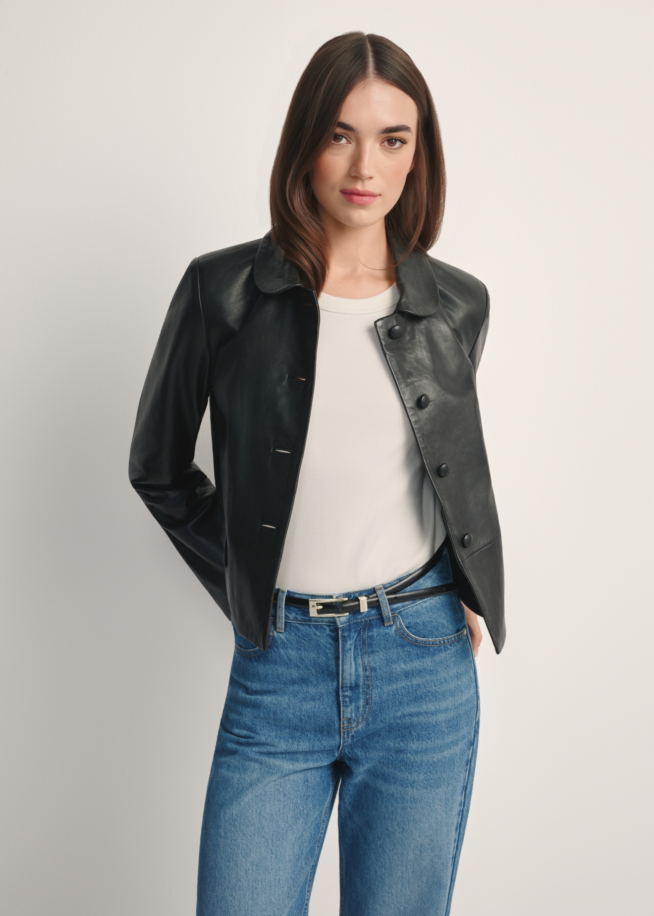 Black short women's leather jacket KURDS-0598-99(W26), product view from the front on the model, half of the silhouette visible.