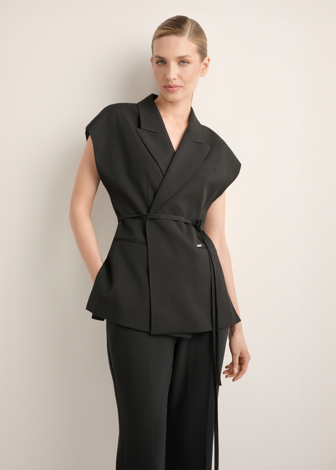 Women's black oversize suit vest KAMDT-0039-99(Z26), front view of the product on the model. Half of the silhouette visible.