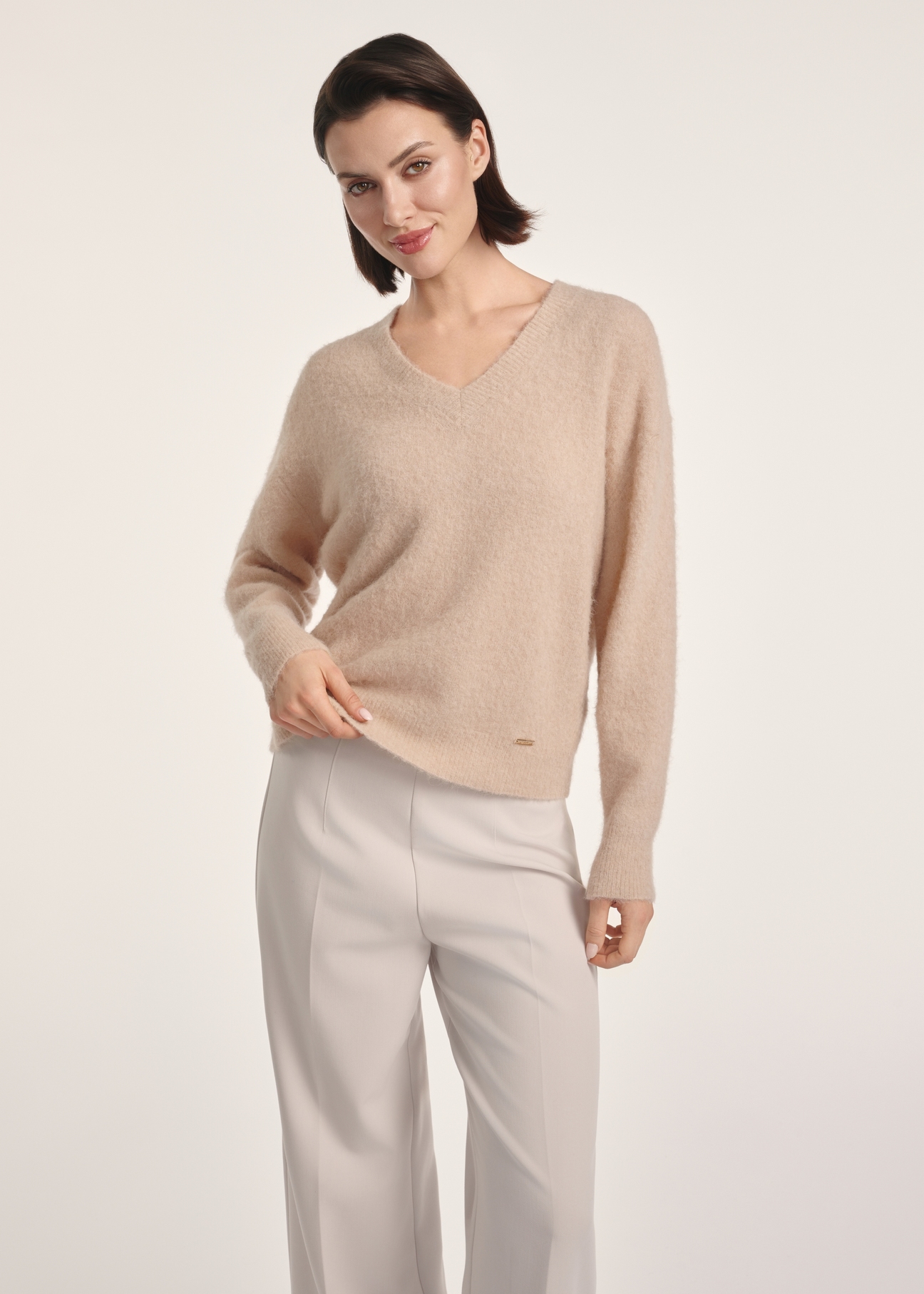 Beige woolen women's sweater SWEDT-0215-81(Z25), front view of the product on the model. Half of the silhouette visible.