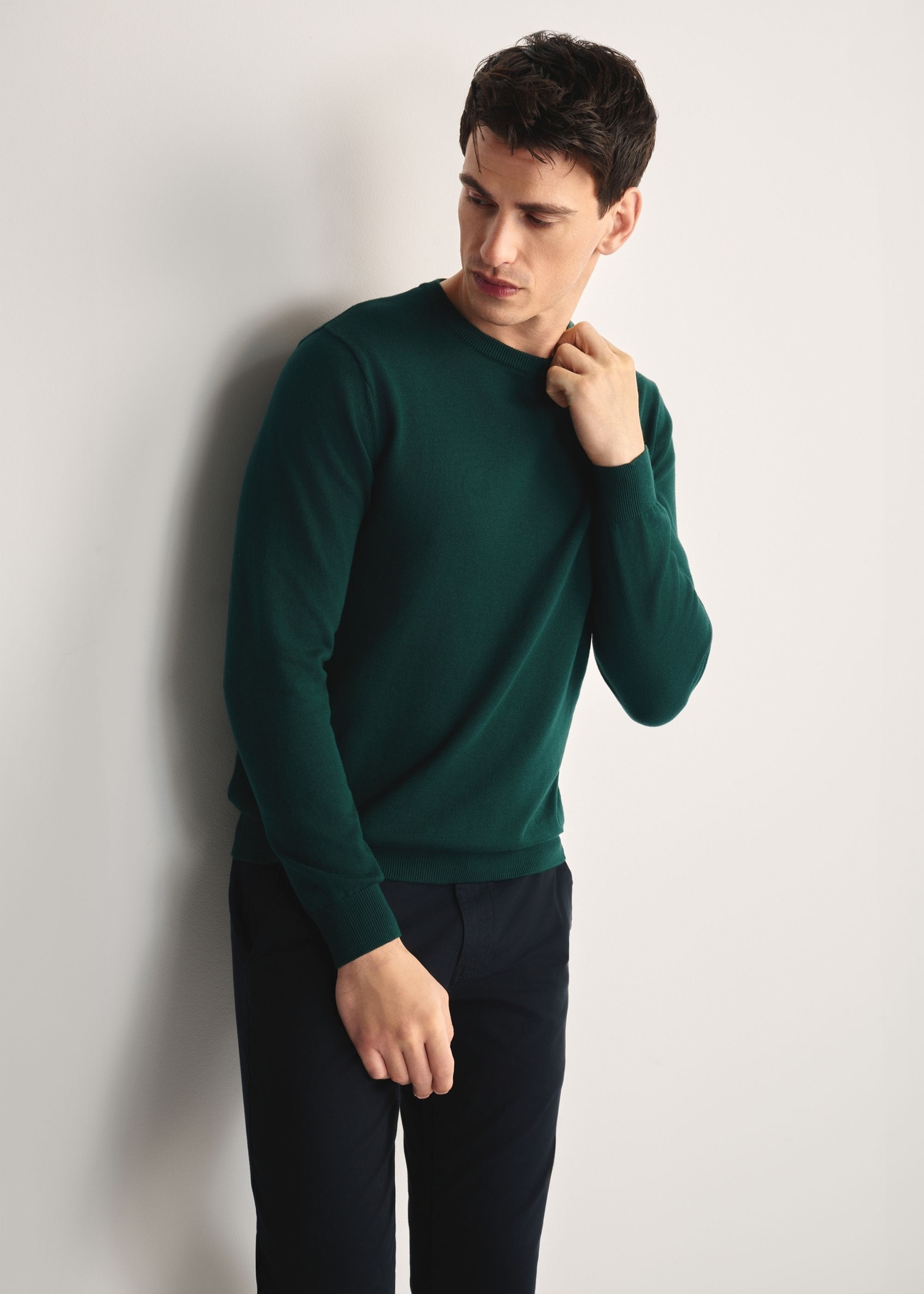 Green men's basic sweater SWEMT-0114A-54(Z25), front view of the product on the model, half of the silhouette visible.