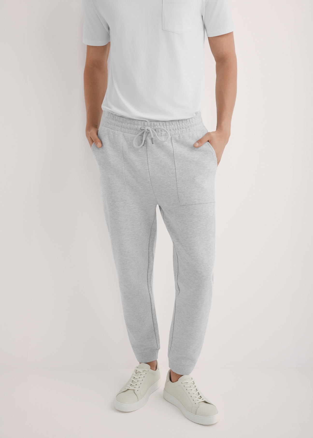 Men's gray sweatpants SPOMT-0116-9A(W26), front view of the product on the model. Half of the silhouette visible.