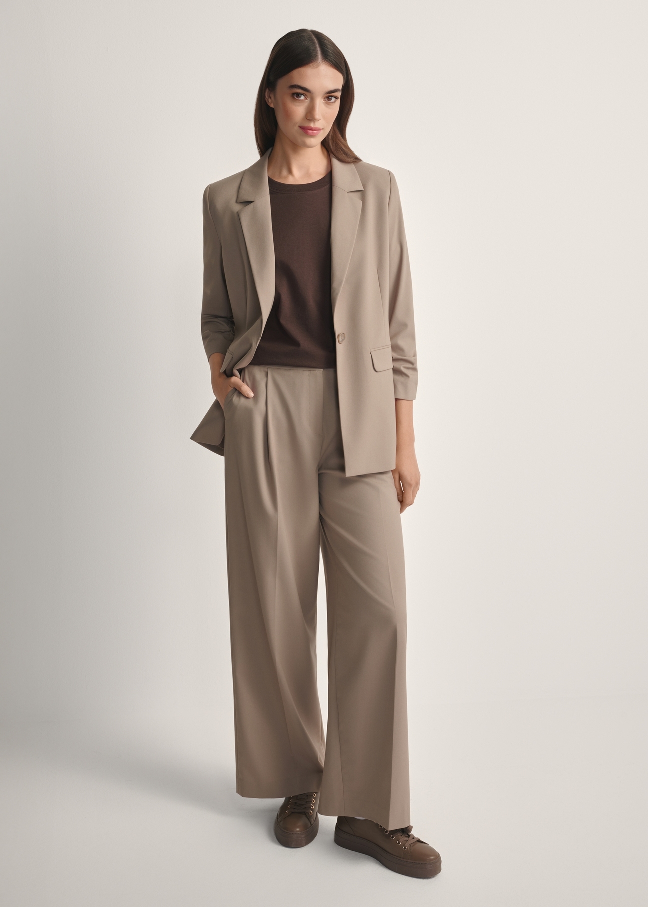 Women's dark beige trousers SPODT-0119-1K(W26), front view of the product on the model. Full body visible.