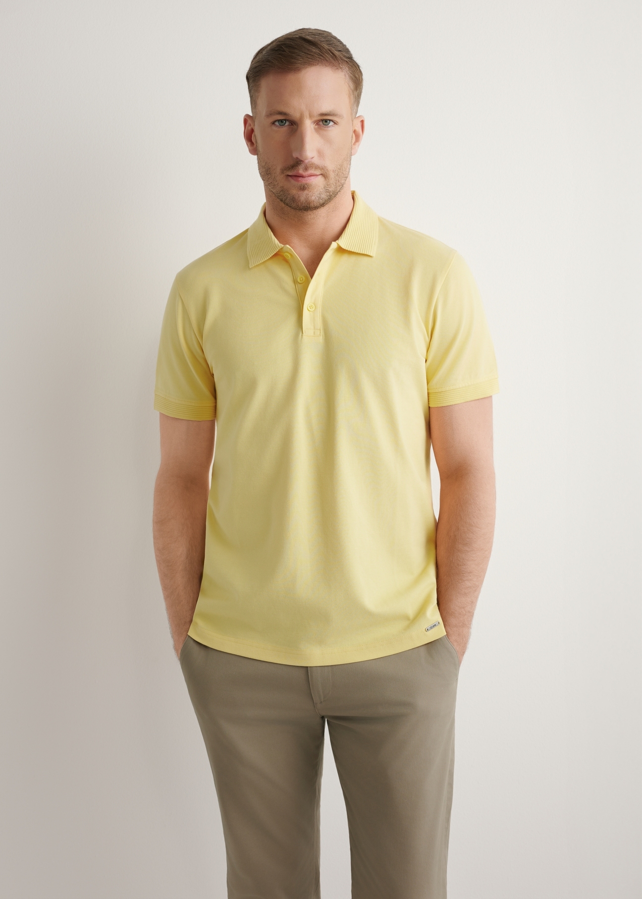 Men's yellow polo shirt POLMT-0089-2B(W26), front view of the product on the model. Half of the silhouette visible.