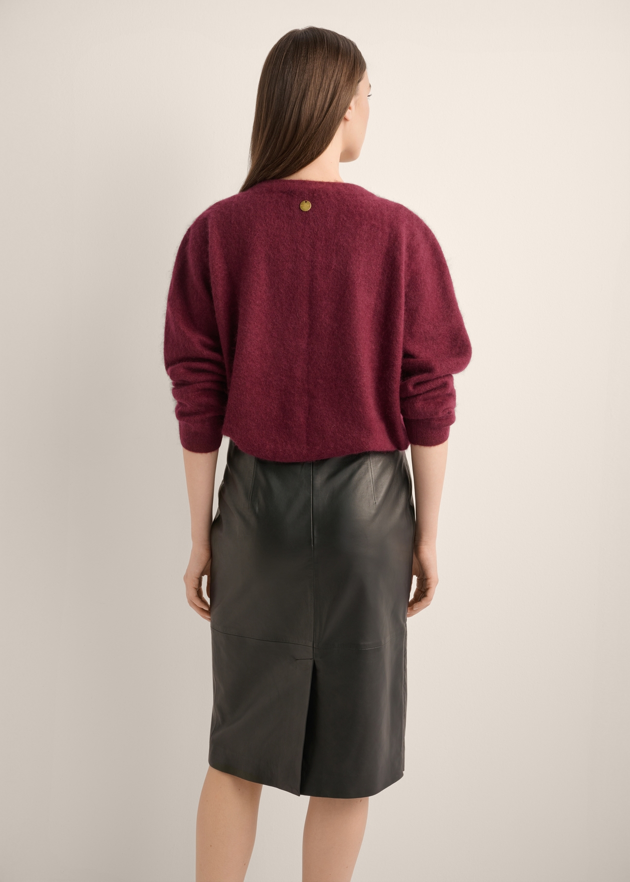 Women's burgundy wool cardigan KARDT-0064-4D(Z26), product view from the back on the model. Half of the silhouette visible.