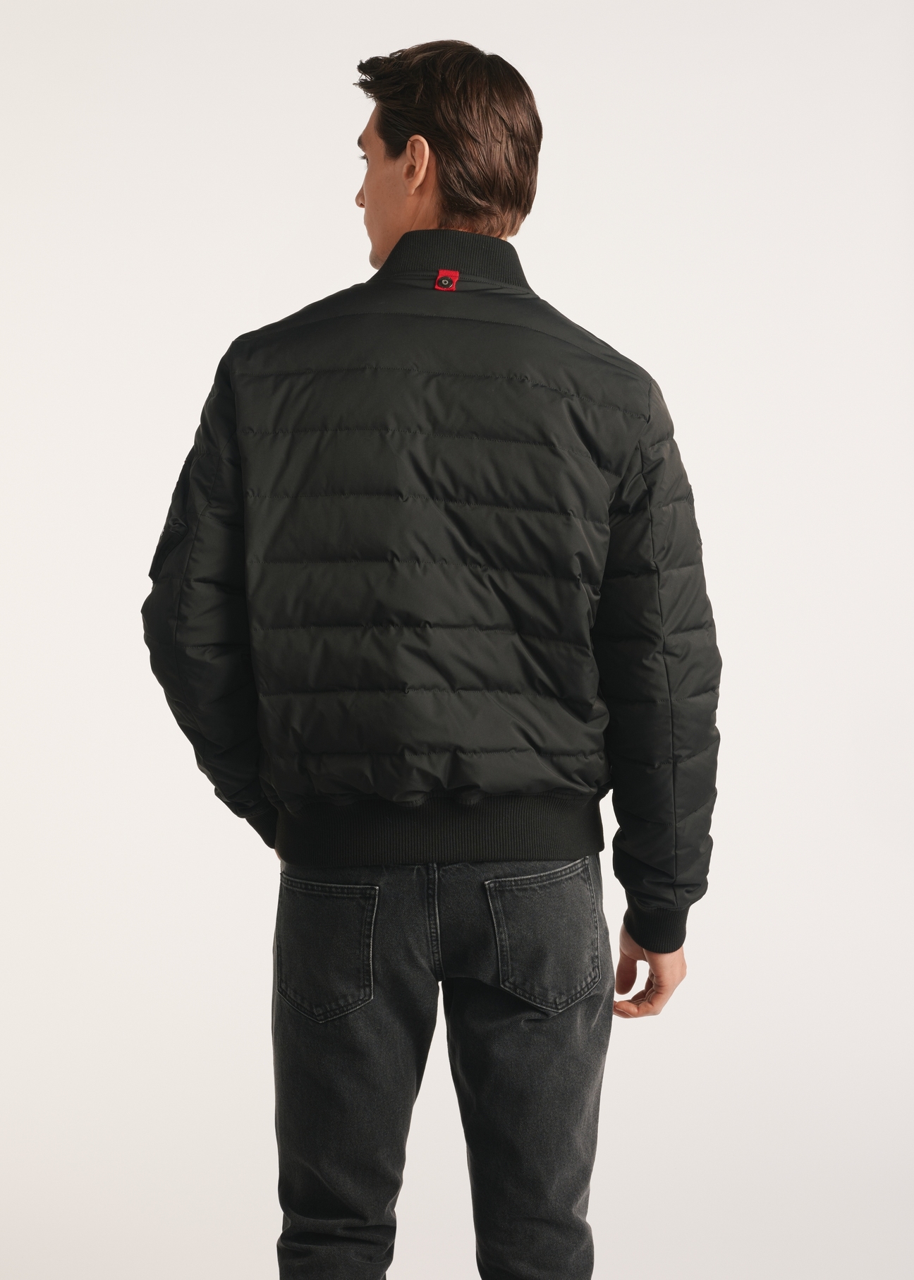 Black insulated men's bomber jacket KURMT-0362-99(Z25), product visible from the back on the model, half of the silhouette visible.