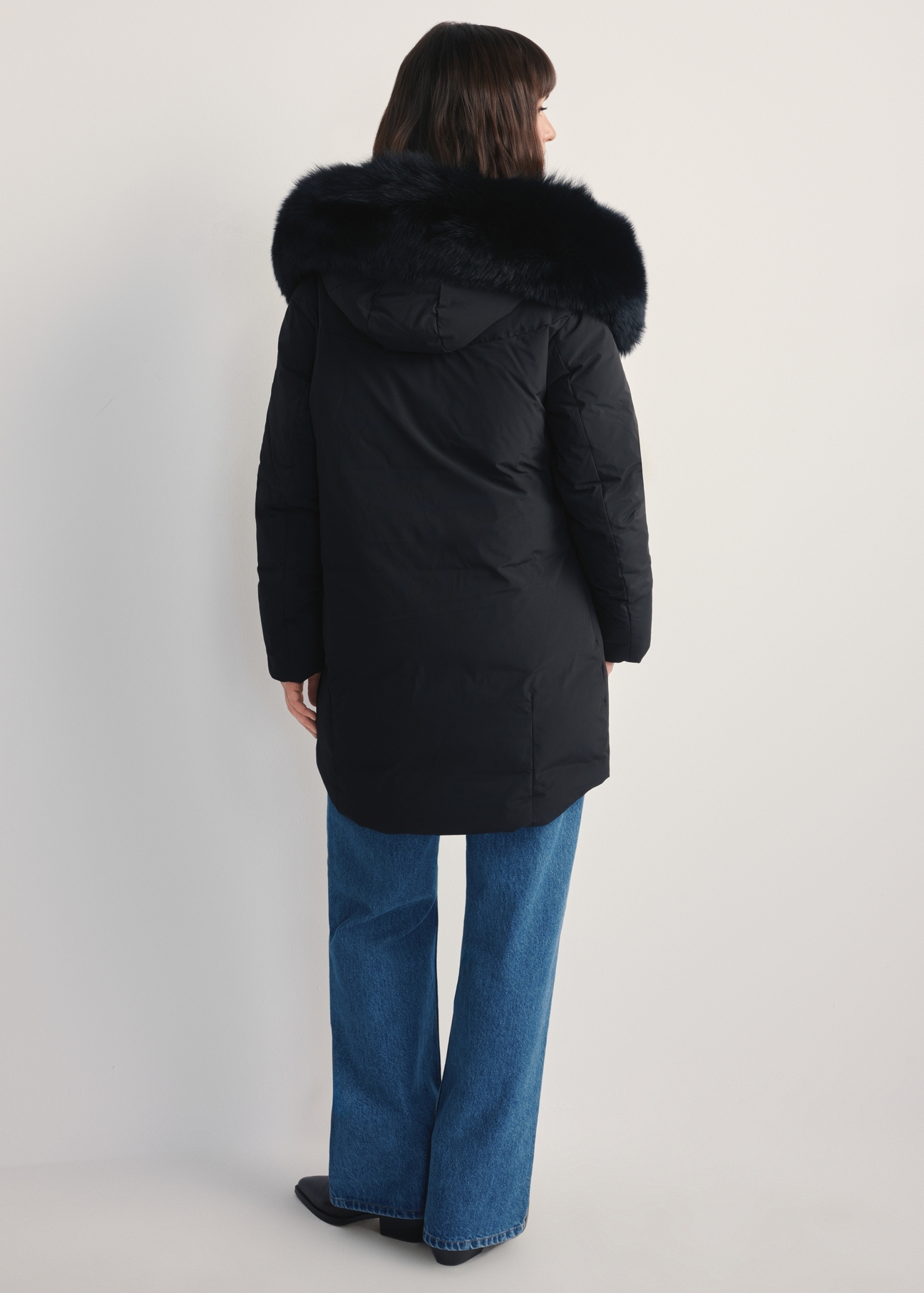 Women's black jacket with natural fox fur KURDT-0594-99(Z25) - back view of the product on a model against a white background. Full body visible.