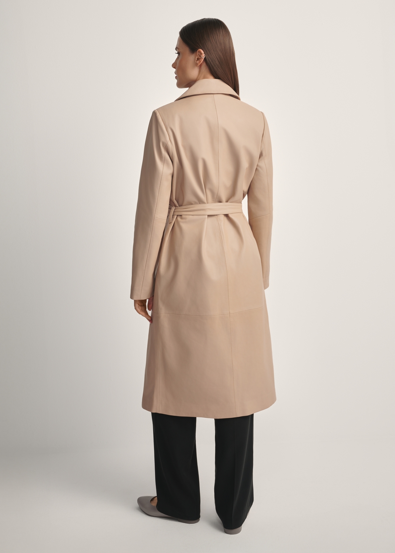 Beige women's leather coat KURDS-0613-1B(W26) - product view of the model from the back, against a light background. Full silhouette visible.