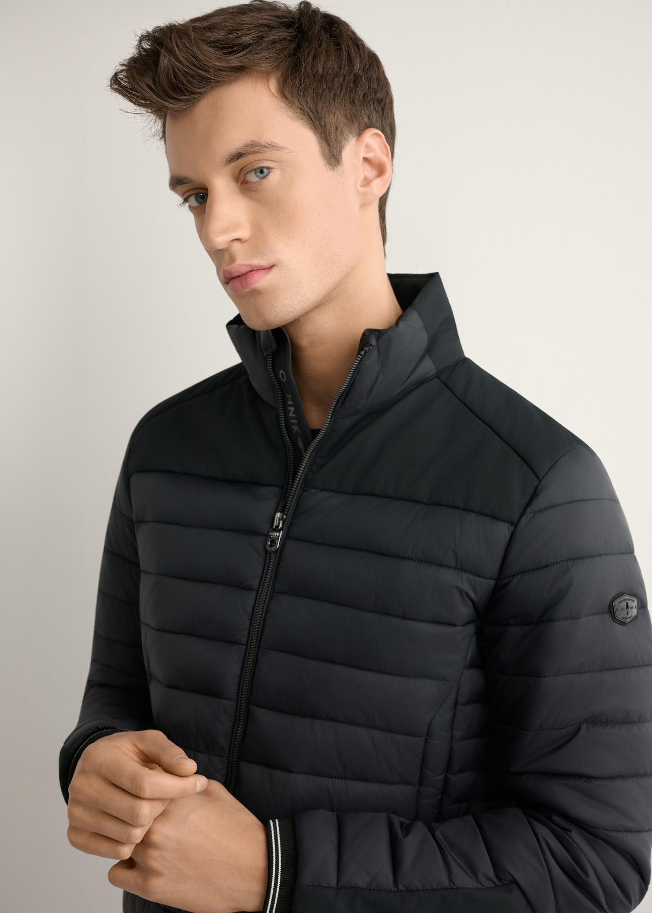 Men's black transitional jacket KURMT-0358A-99(W26) - front view of the product on a model, against a light background. Half of the silhouette visible.