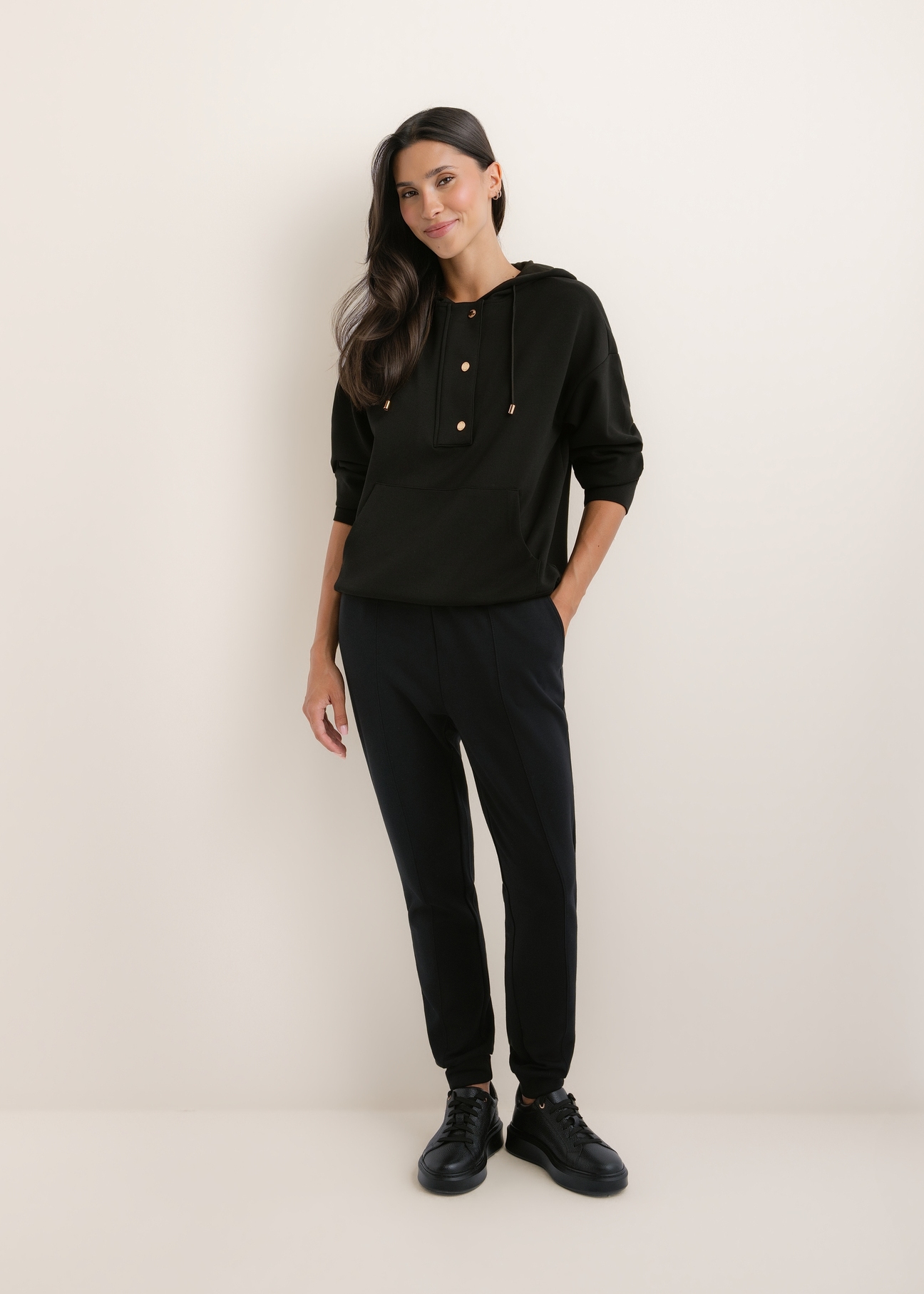 Women's black trousers SPODT-0108-99(W26), front view of the product on the model. The entire silhouette is visible.