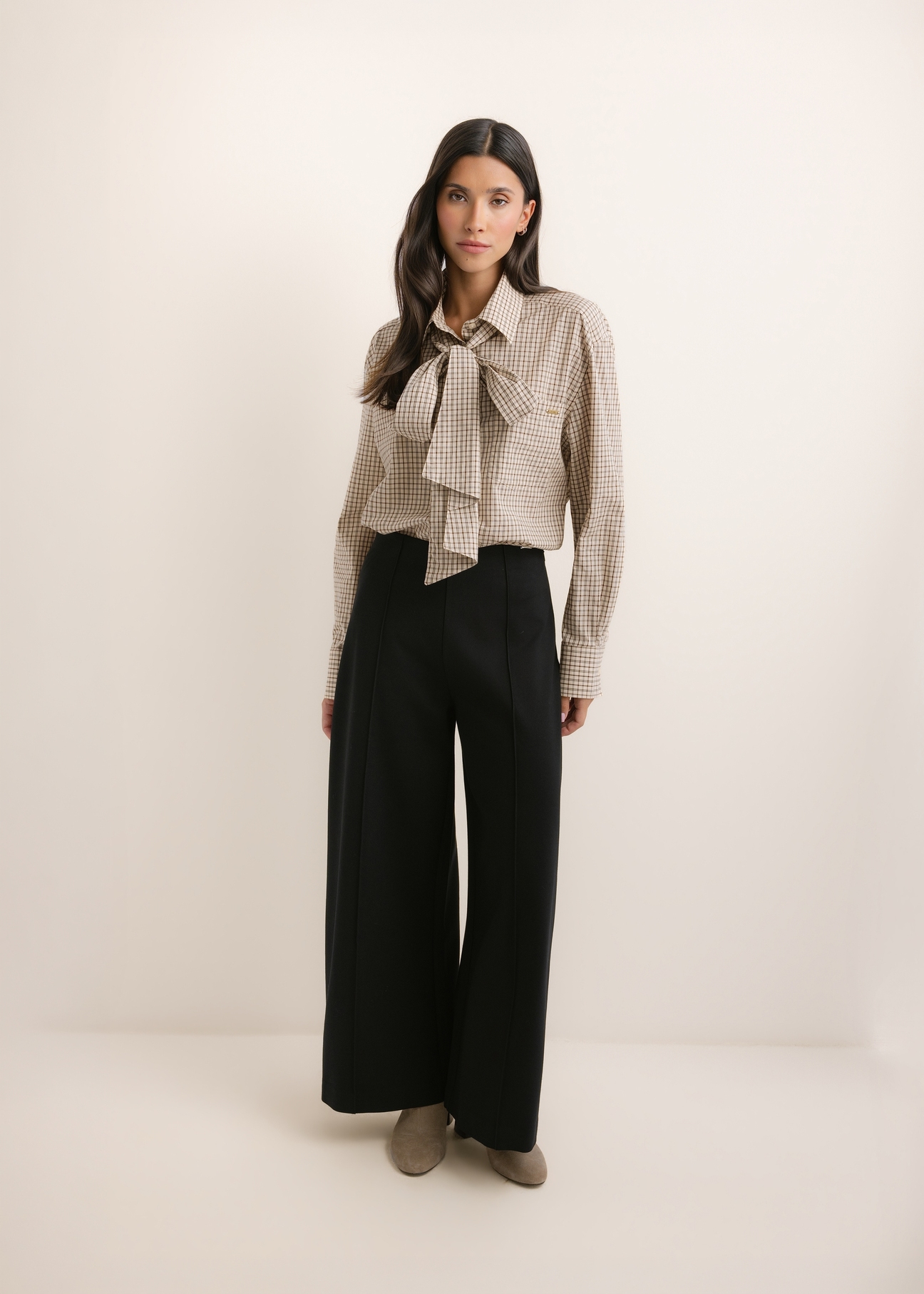 Black women's wide leg trousers SPODT-0130-99(Z26), front view of the product on the model. The entire silhouette is visible.