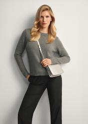 Silver women's handbag TOREC-1070-91(Z25), front view of the product on the model, half of the silhouette visible.