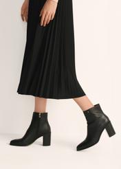 Black leather women's ankle boots BUTYD-1213-99(Z25), product view on model's feet against a light background.