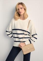 Small beige women's handbag TOREC-1015-1B(W26), front view of the product on a model, half of the silhouette visible.