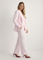 Women's pink blazer ZAKDT-0031A-5A(W26), side view of the product on the model. Full body visible.