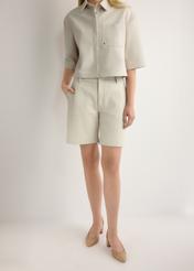 Women's cream leather shorts SPODS-0047-0B(W26), front view of the product on the model. Half of the silhouette visible.