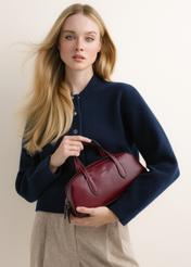 Small dark red women's handbag TOREC-1382-4C(Z26); front view of the product held in a model's hands against a light background.
