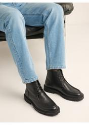 Men's black leather ankle boots BUTYM-0578-9I(Z26), diagonal view of the product on the model. Half of the silhouette visible.