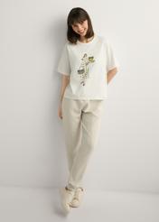 Cream women's T-shirt with print TSHDT-0161-0B(W26), front view of the product on the model. Full body visible.