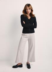 Black women's cardigan with buttons KARDT-0044A-99(Z25), front view of the product on the model, the whole silhouette is visible.