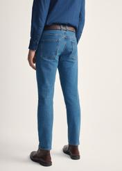 Men's dark blue jeans JEAMT-0024-61(Z25), back view of the product on the model. Half of the silhouette visible.
