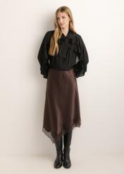 Dark brown asymmetrical women's skirt SPCDT-0135-1I(Z26), front view of the product on the model. Full body visible.