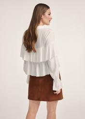 Women's white blouse with frills BLUDT-0198-12(Z25), product view from the back on the model. Half of the silhouette visible.