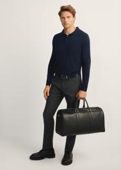 Black travel bag TORMS-0470-99(Z25), front view of the product on the model, the entire silhouette is visible.