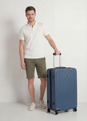 Large suitcase on wheels WALAB-0053-69-29(W25), product view diagonally next to the model, the entire silhouette is visible.