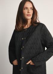 Women's long black quilted jacket KURDT-0631-99(W26) - front view of the product on a model, against a white background. Half of the silhouette visible.