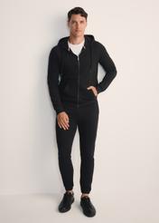 Black men's sweatpants SPOMT-0101-99(Z25), product view from the front on the model, the entire silhouette is visible.